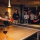 Amis jouant au ping-pong et riant lors d'une soirée privée au Gossima ping pong bar Paris